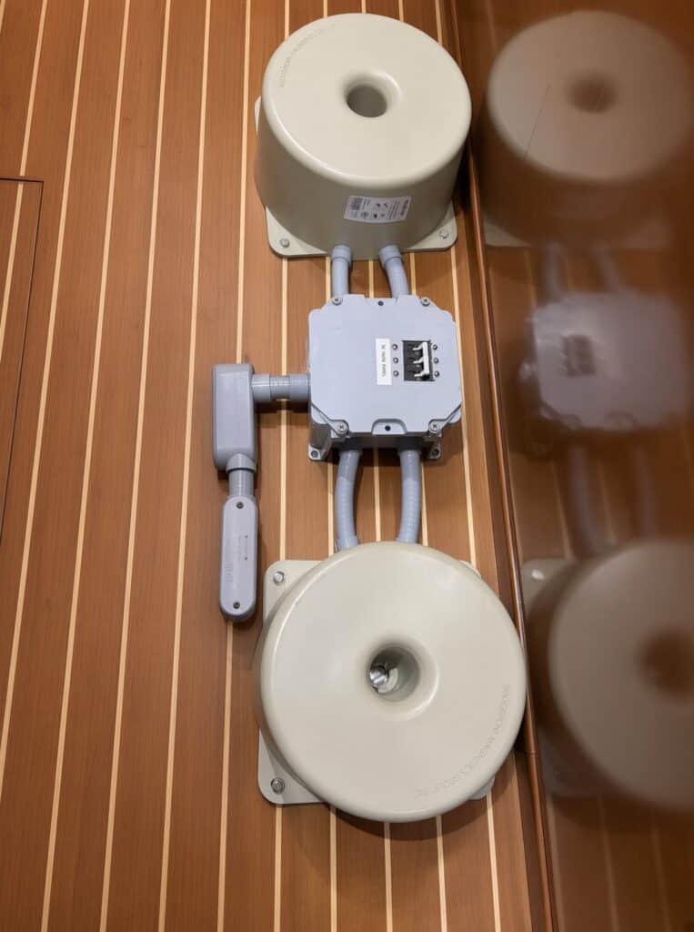 Marine-Puck Dual MP6 isolation transformer mounted on boat bulkhead with color-coded leads exiting the non-metallic ABS enclosure